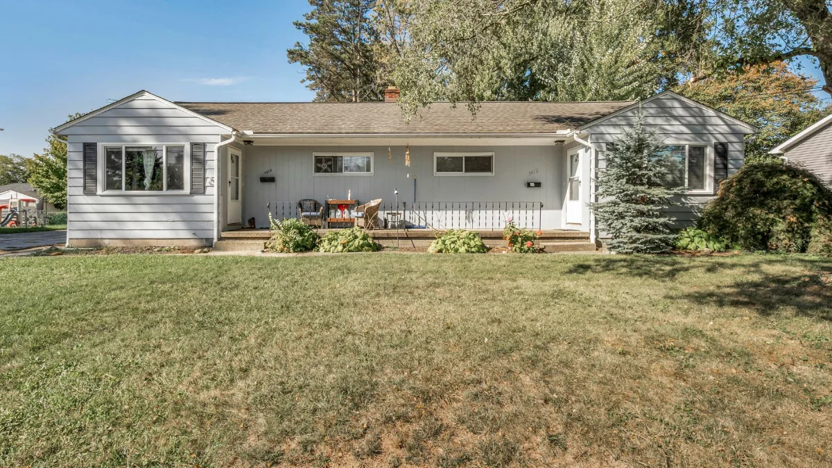 Single-story ranch house with a green front lawn