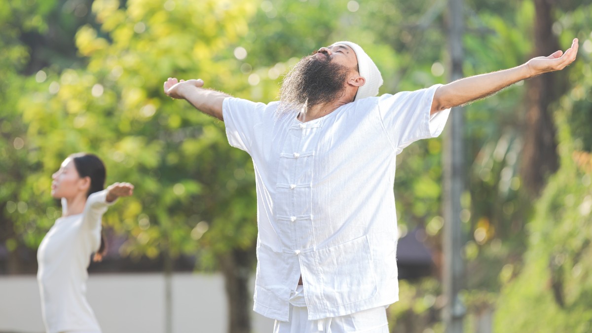two people white outfit meditating nature